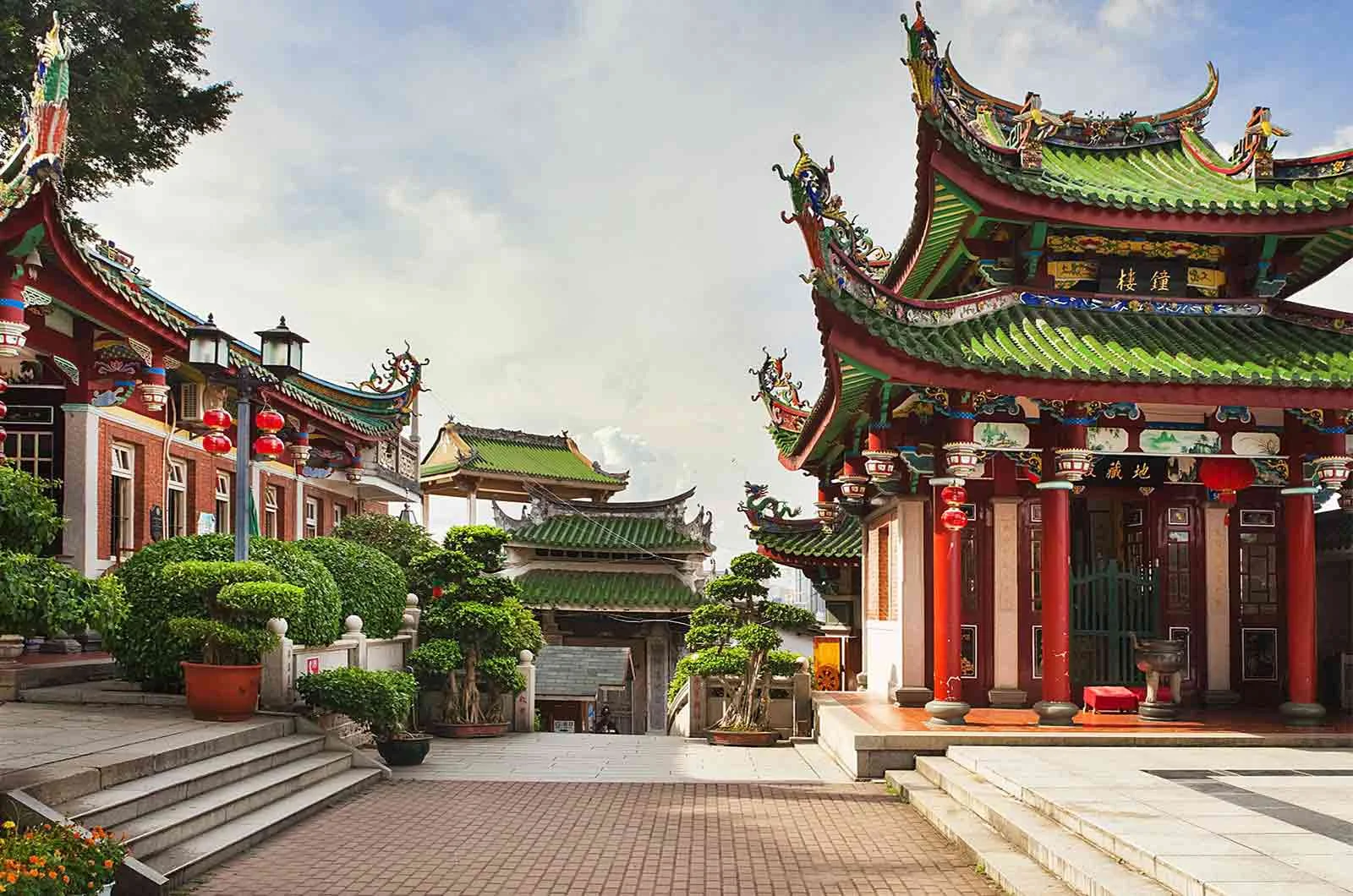 A temple in China contains colourful and decorated buildings, trees and lights. Concept of Mandarin translation services and Mandarin translators.