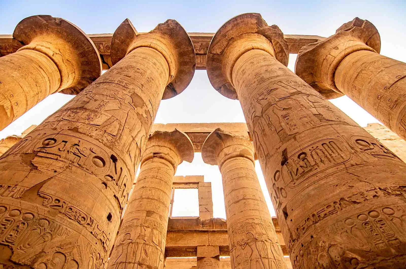Colossal columns from the Pharaonic period engraved with hieroglyphs in Luxor, Egypt. Concept of Arabic translations.