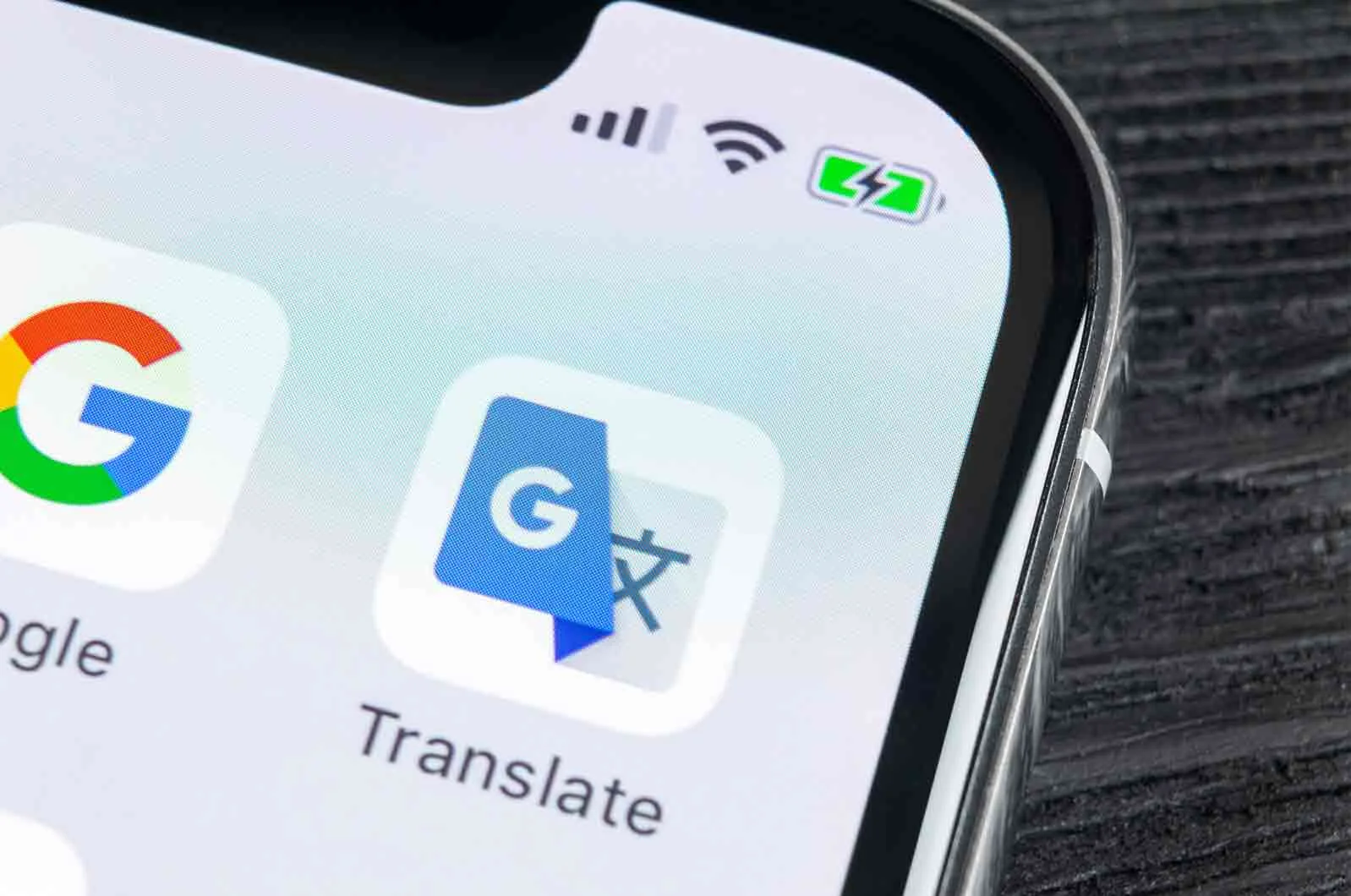 Close-up of a Google Translate icon on a smartphone. Concept of translation tools and machines.