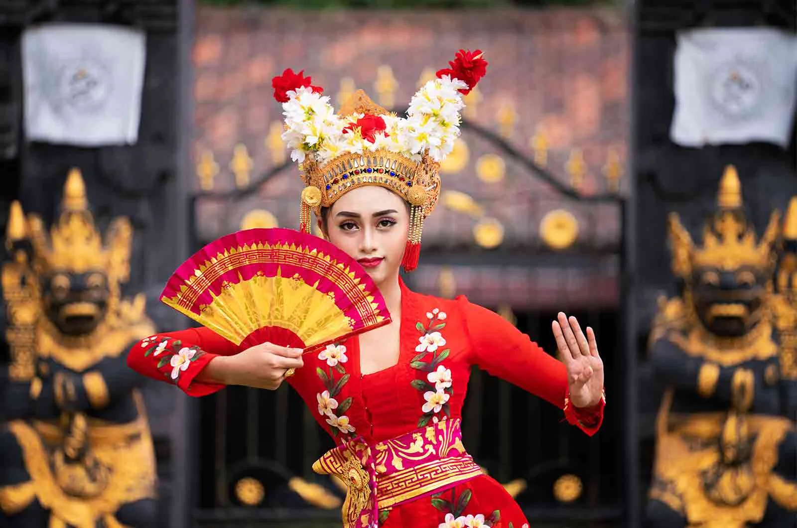 An Indonesian girl wears a traditional dress and dances a traditional dance. Concept of Indonesian translations.