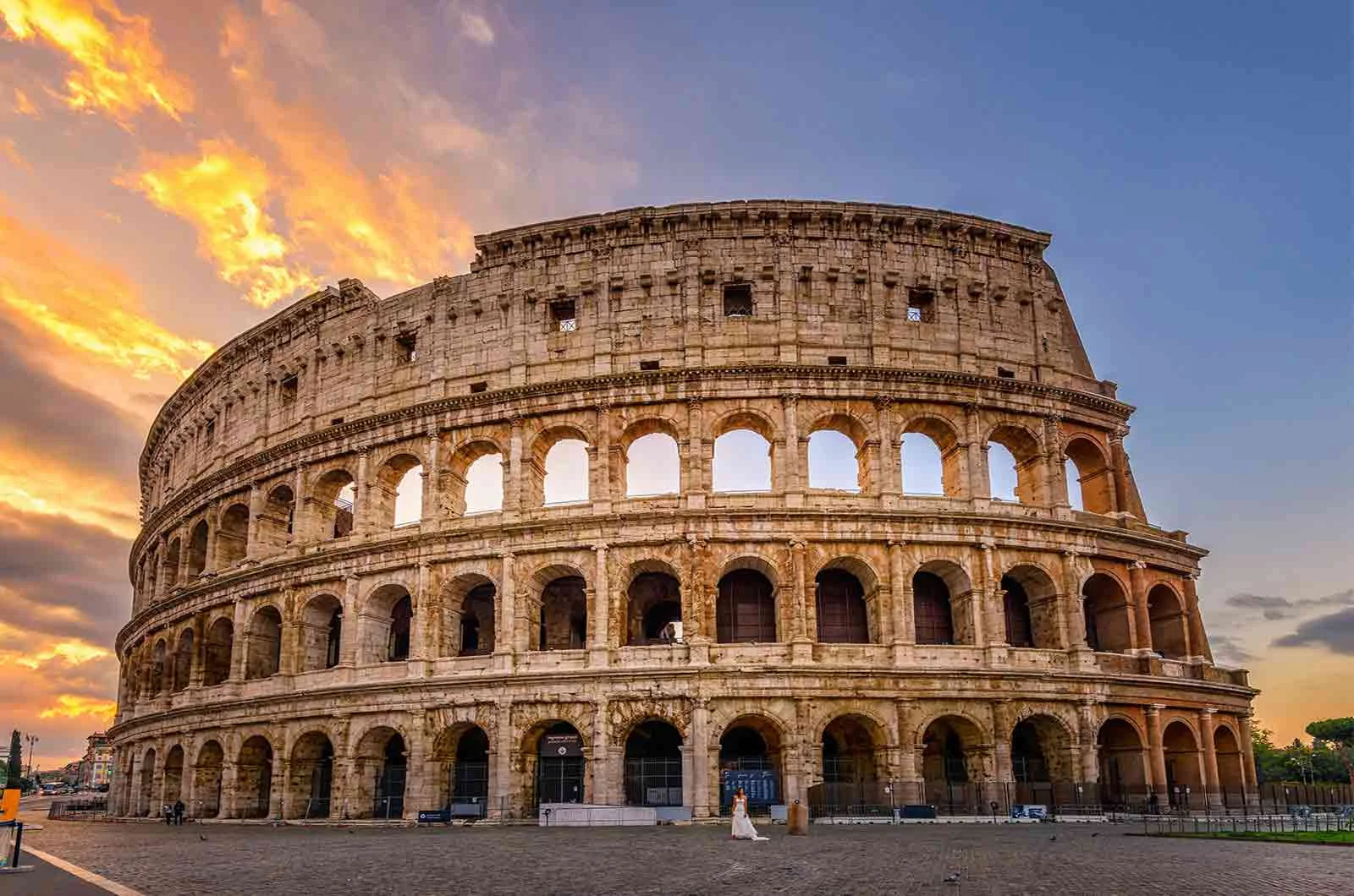 Sunrise behind the Colosseum in Rome, showing the beauty of ancient architecture. Concept of Italian translations.