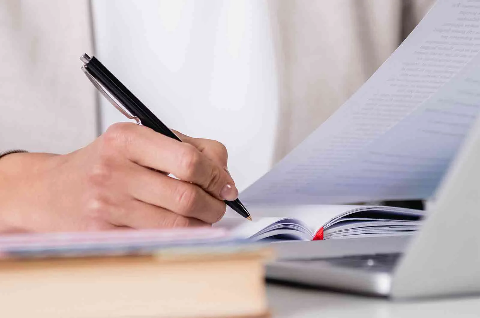 An employee reviews and checks information and takes notes with a computer. Concept of literal translation.