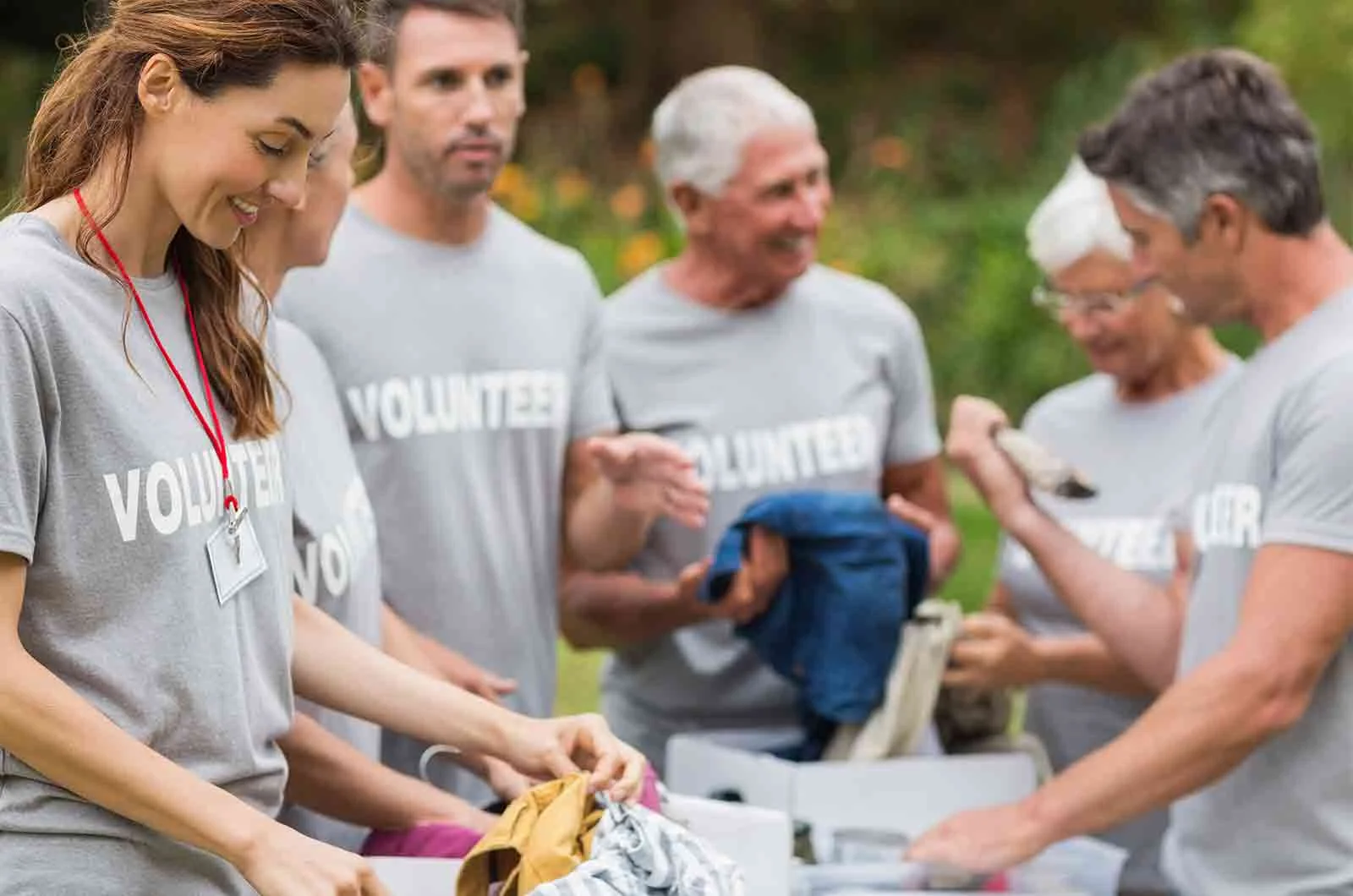A group of volunteers working and wearing T-shirts with the word 