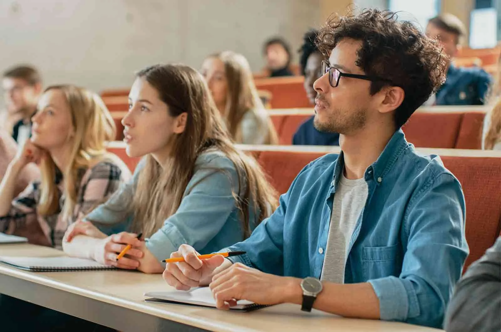 Students focused in their lecture and looking directly at the lecturer. Concept of Academic translations.