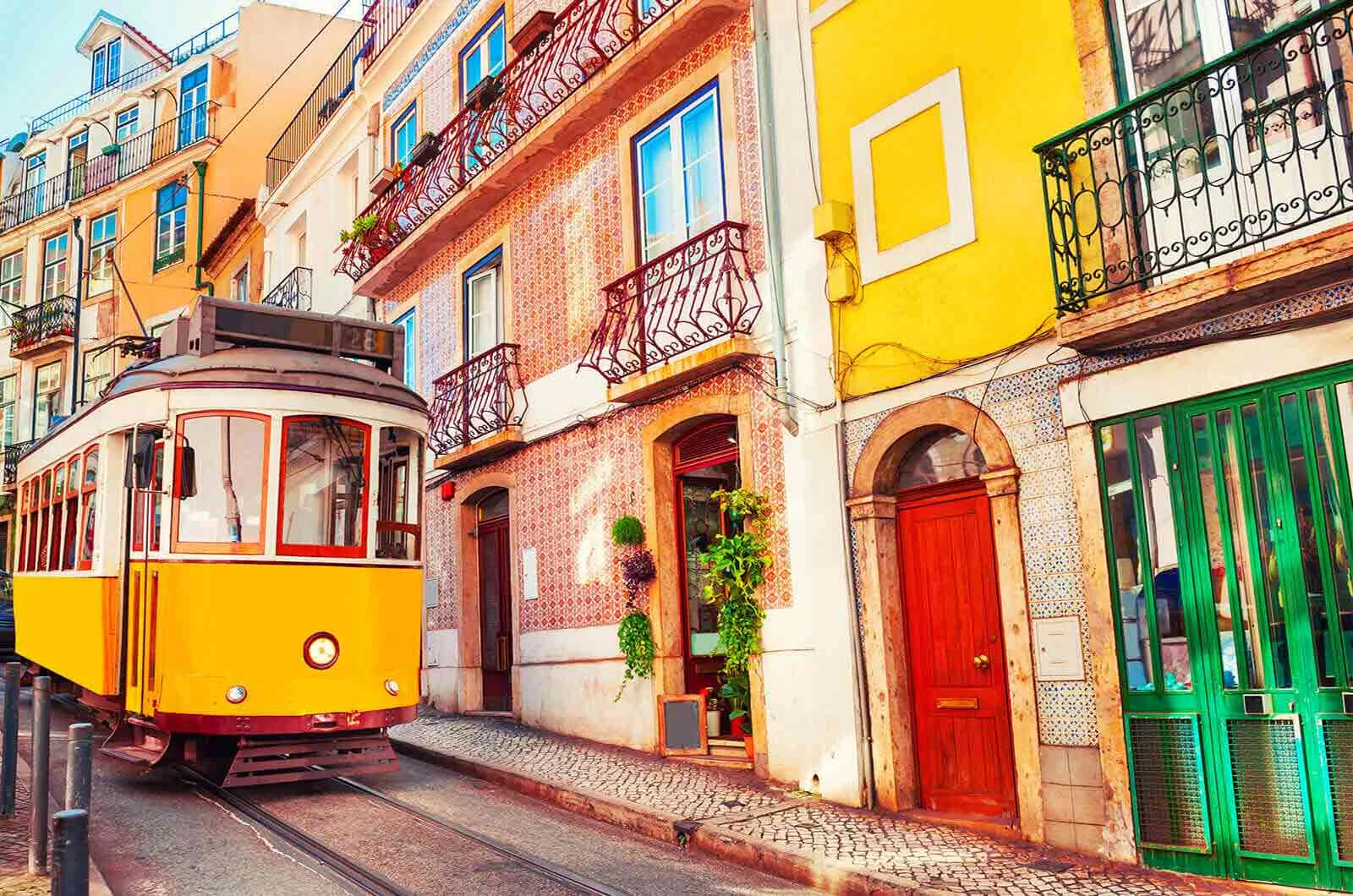 A yellow train in the city centre of Lisbon, Portugal. 