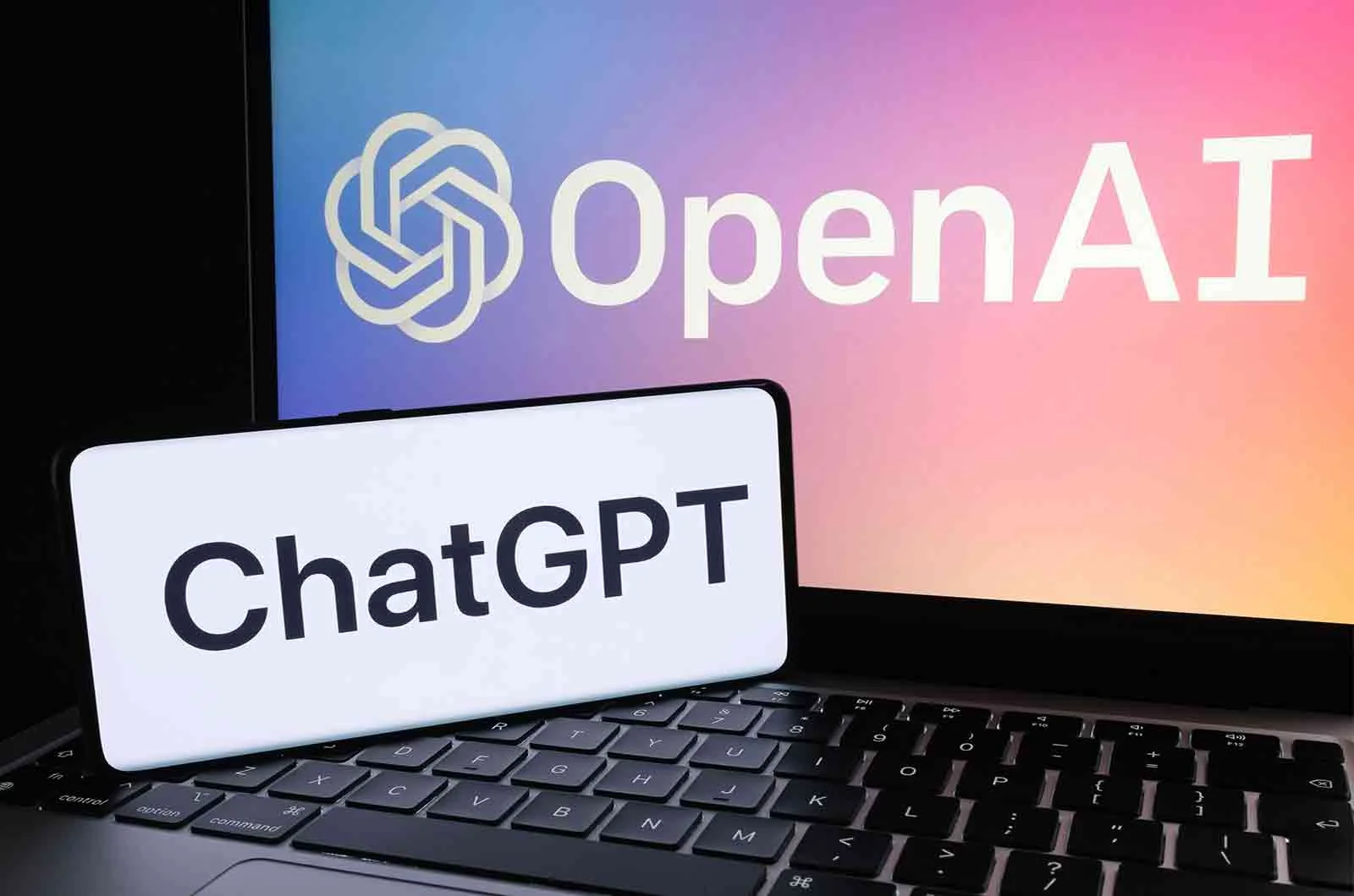 Chatgpt logo and OpenAI company logo displayed on laptop screen and smartphone. Concept of chatgpt translation using chatgpt 3 online.