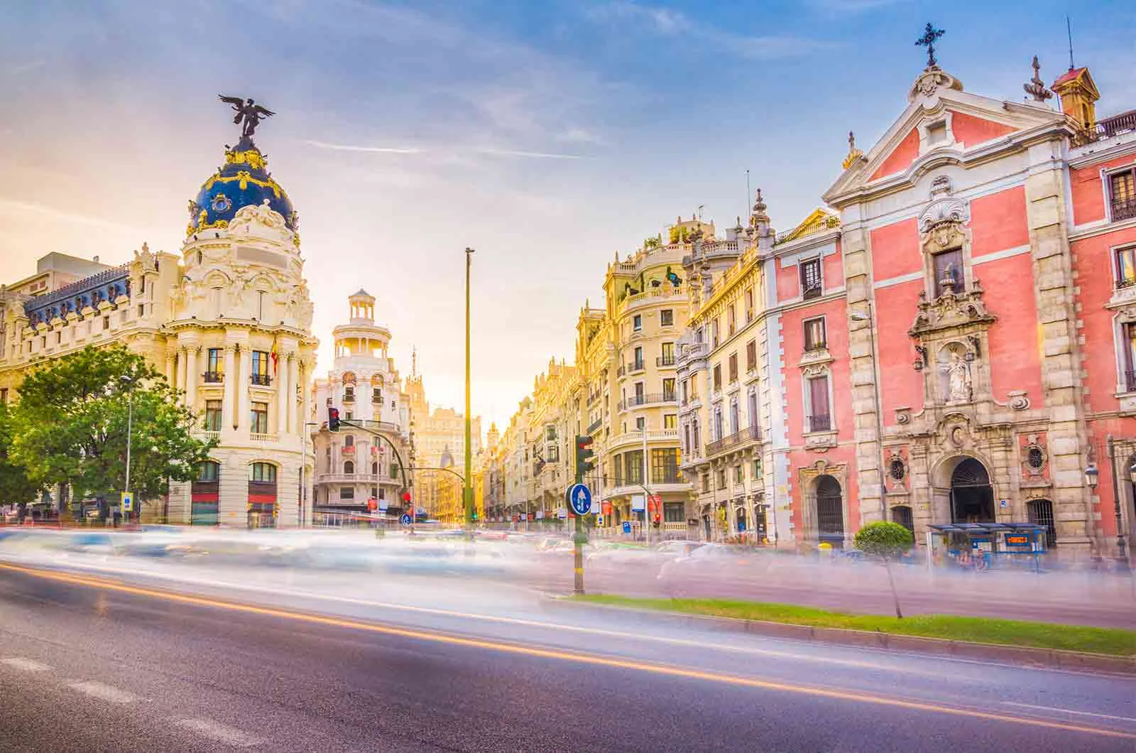 Metropolis Building in Madrid, Spain with high speed cars on the road. Concept of translation to Spanish. 