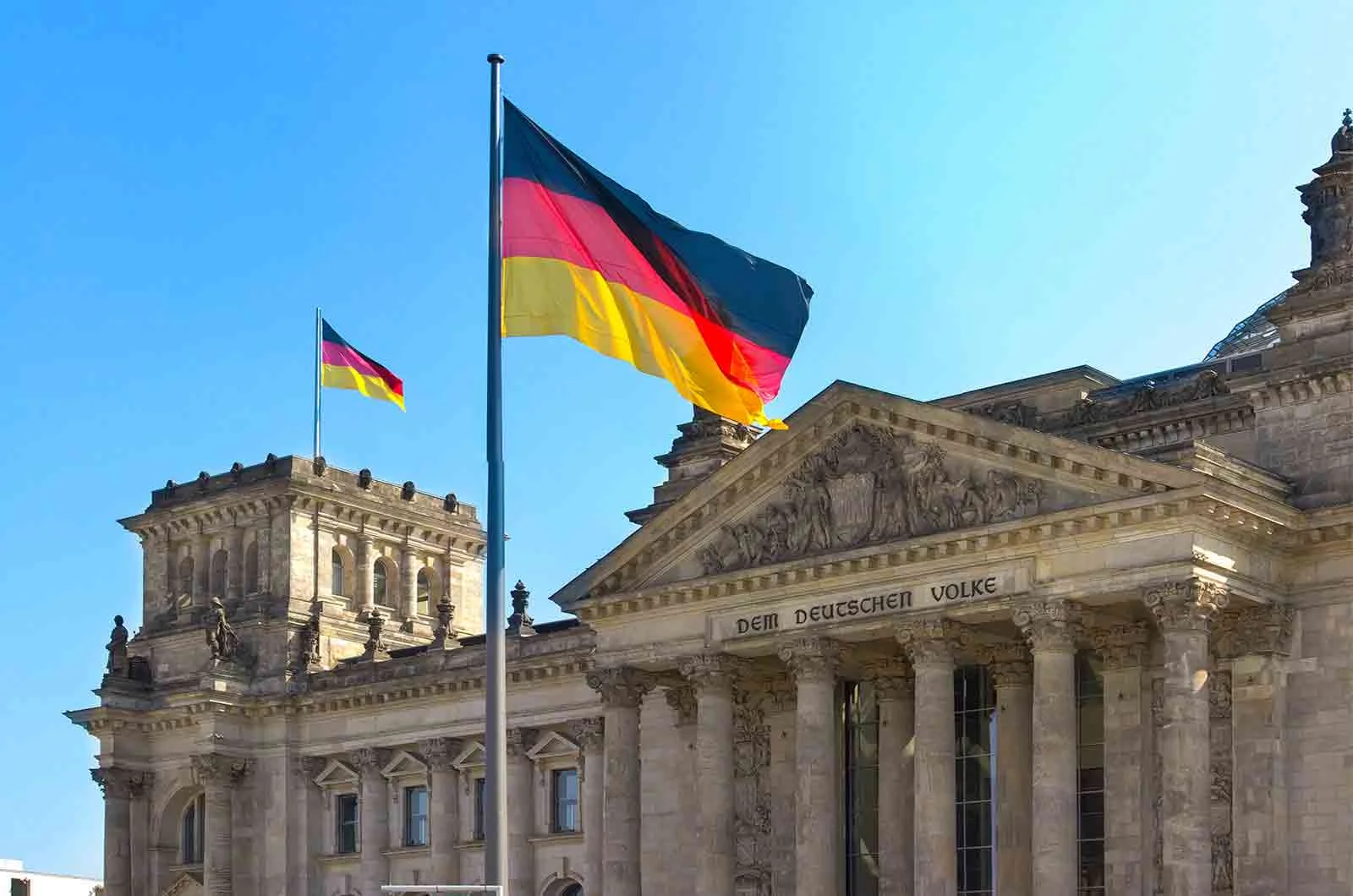 The flag of Germany at the top of Reichstag Building in Berlin. 