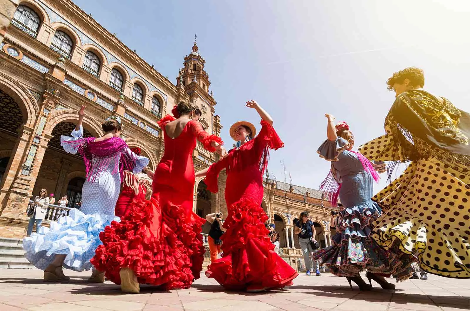 Traditionally dressed Spanish women performing in the square of a Spanish city. Concept of Spanish translations.