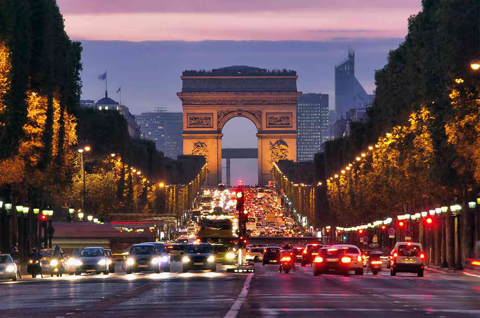 The Champs-Elysees in Paris at sunset, with cars on the way. Concept of English to French translators.