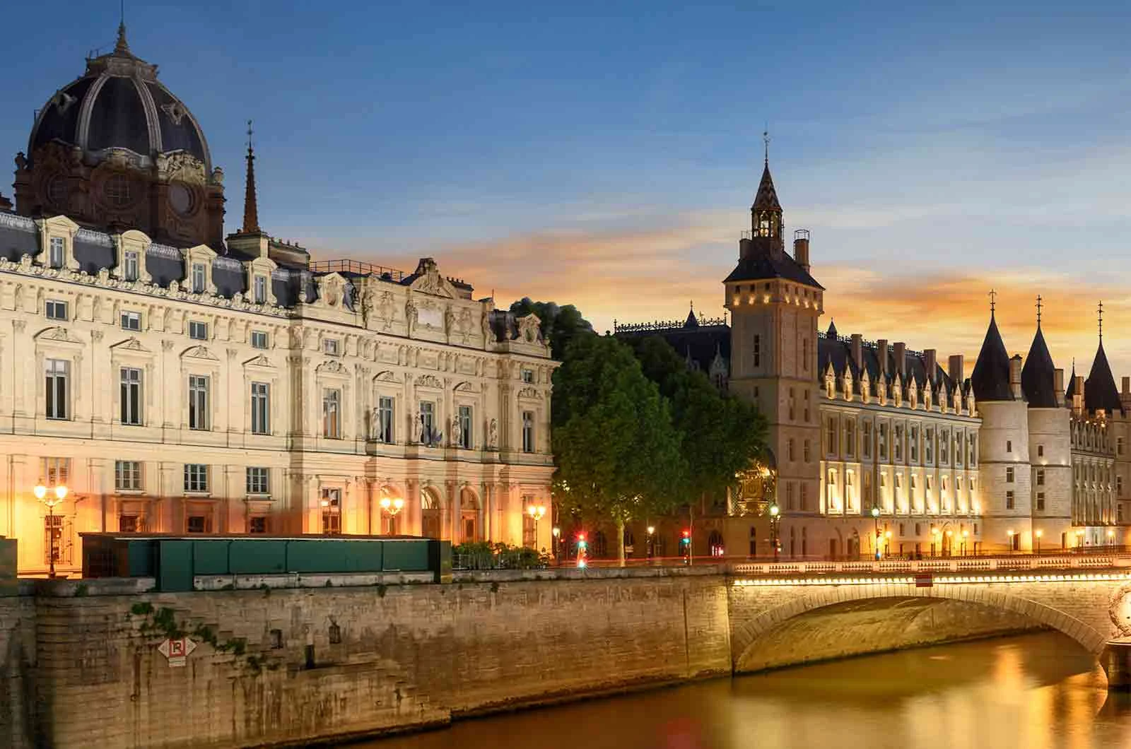 Conciergerie, Pont Neuf and Seine river at sunset in French capital, Paris. Concept of English to French translation.