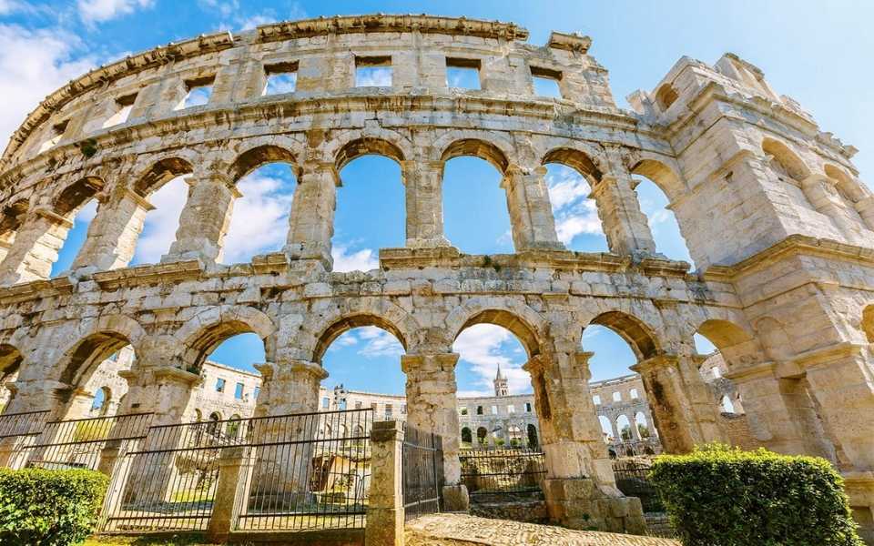 Exterior of an ancient Roman amphitheatre in Pula, Croatia. Concept of English to Croatian translation.