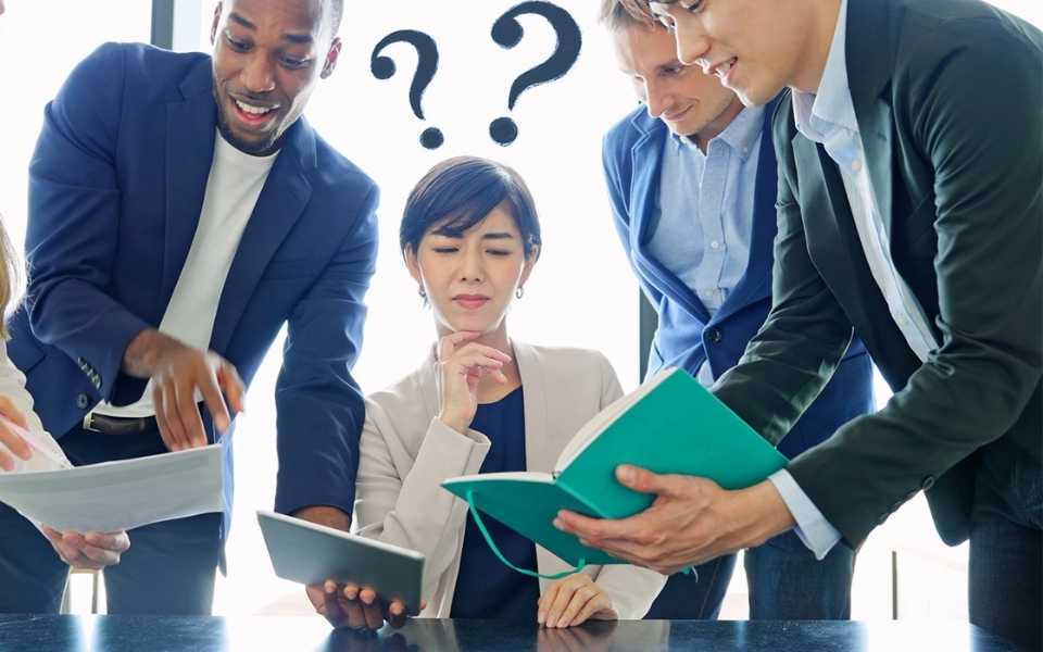 An Asian woman is confused and some employees are conversing with her. Concept of choosing language service provider.