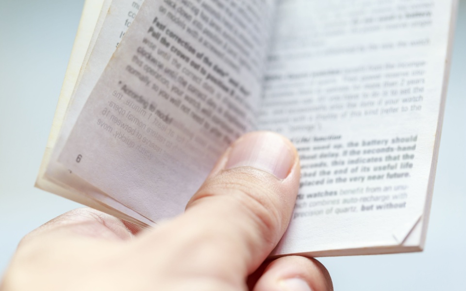 A customer reading a user manual. User and product manual translation.