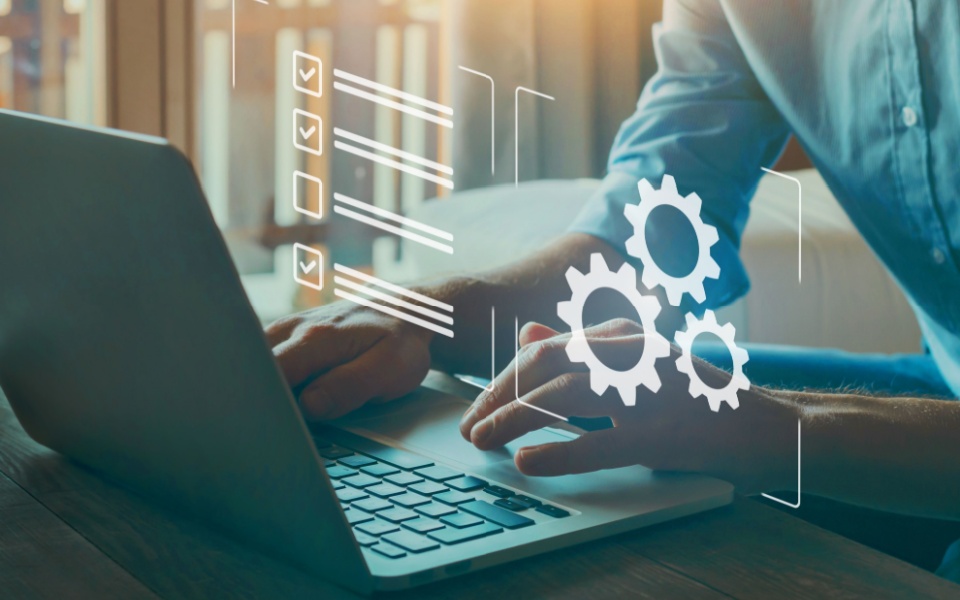 Man hands working on laptop showing automatic translation and automated translation workflows with checkboxes in the background. 