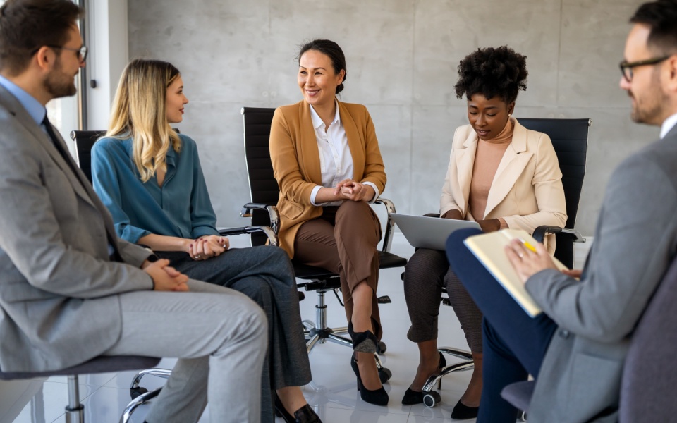 A multinational team holding a meeting in a modern office. 