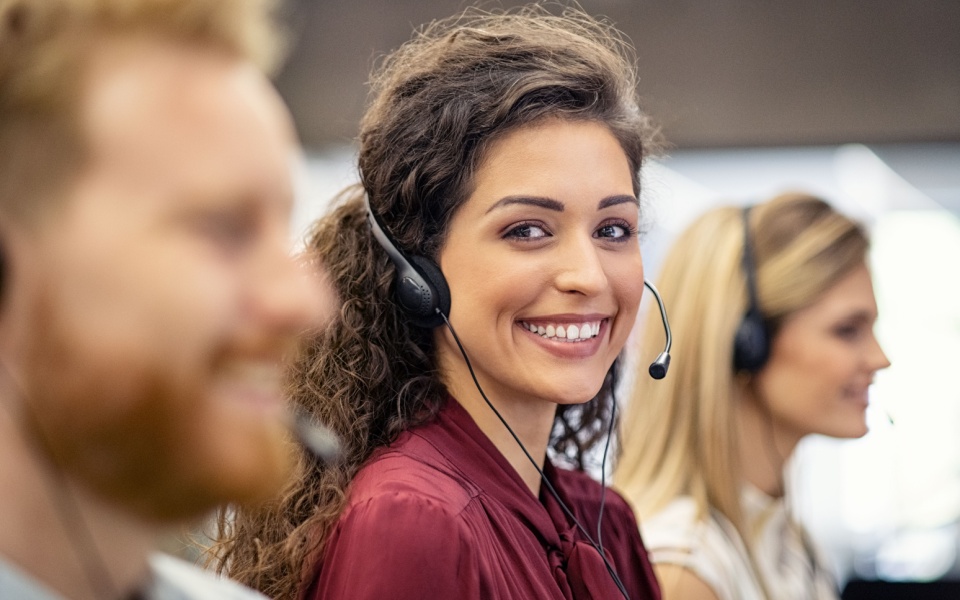 Two female and one male call center team providing multilingual customer support for international clients. 