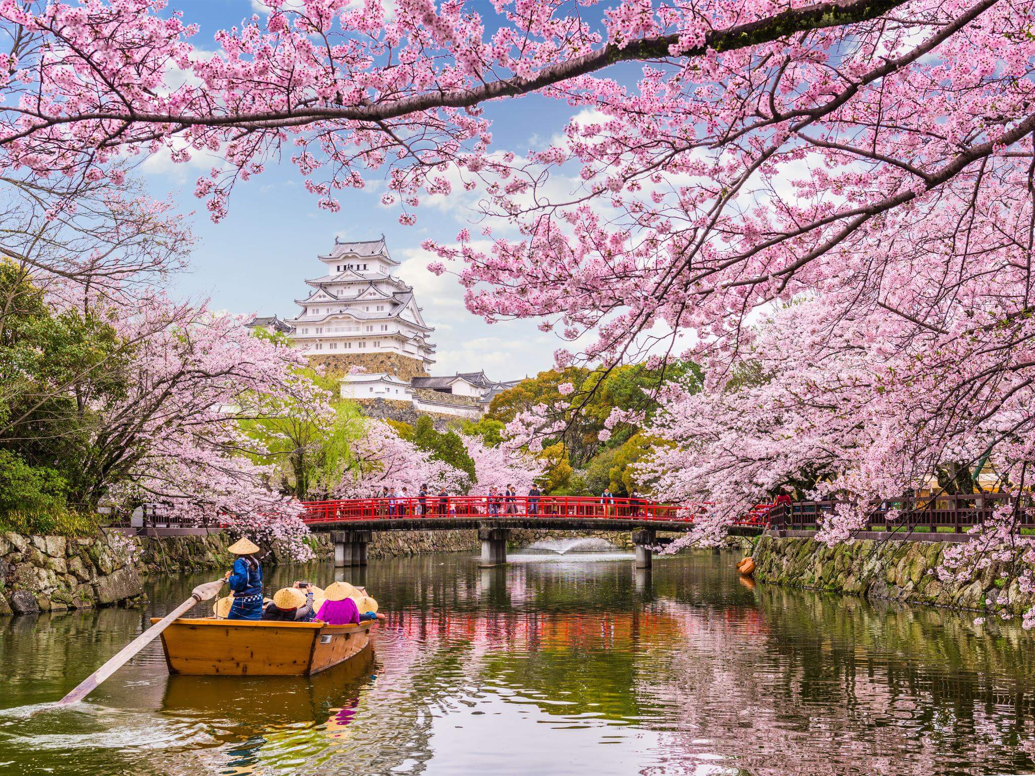 Himeji Castle in Japan during a spring season, with people using a boat. Concept of the origin of the Japanese language and speaking Japanese.