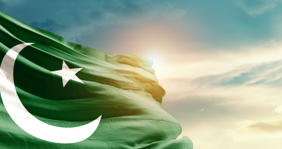 The Pakistani green and white flag waving in sunshine. Concept of Urdu translation services by professional Urdu translators.