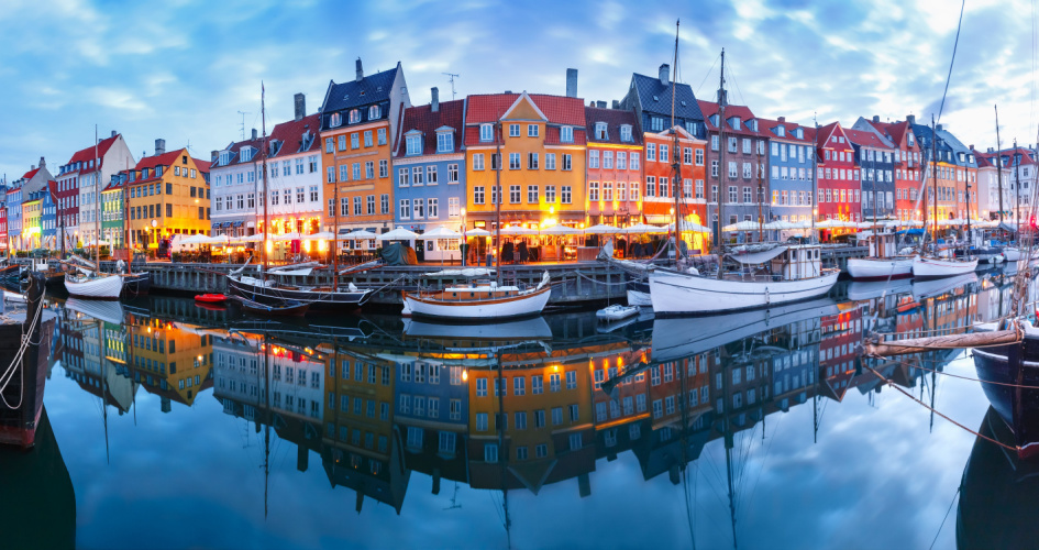 Nyhavn, a 17th-century waterfront, canal and entertainment district in Copenhagen, Denmark. Concept of Danish translation by professional Danish translators.