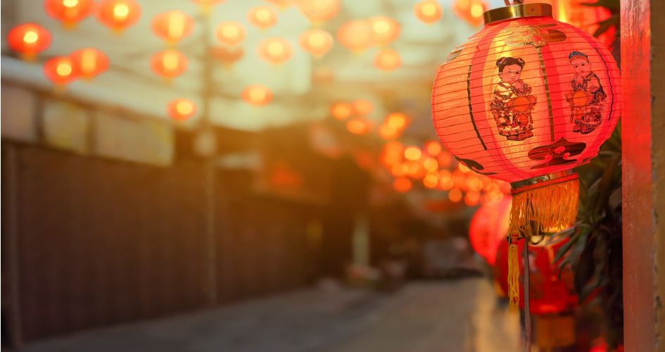 One Chinese New Year lantern in focus with many others in background. Concept of Chinese translation services by professional English Chinese translators.