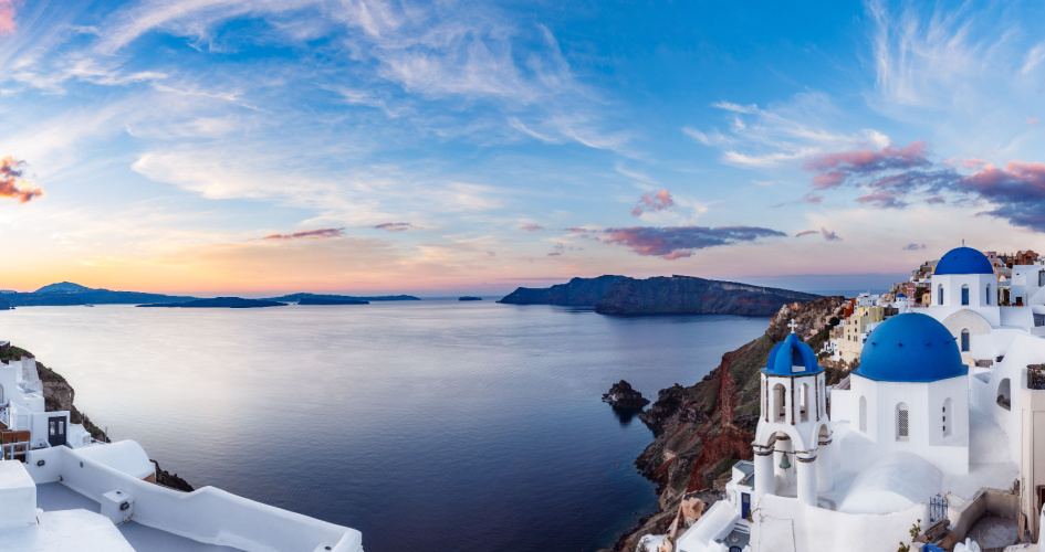 The Santorini Caldera, with white buildings to the left and right. Concept of Greek translation services by professional Greek translators.