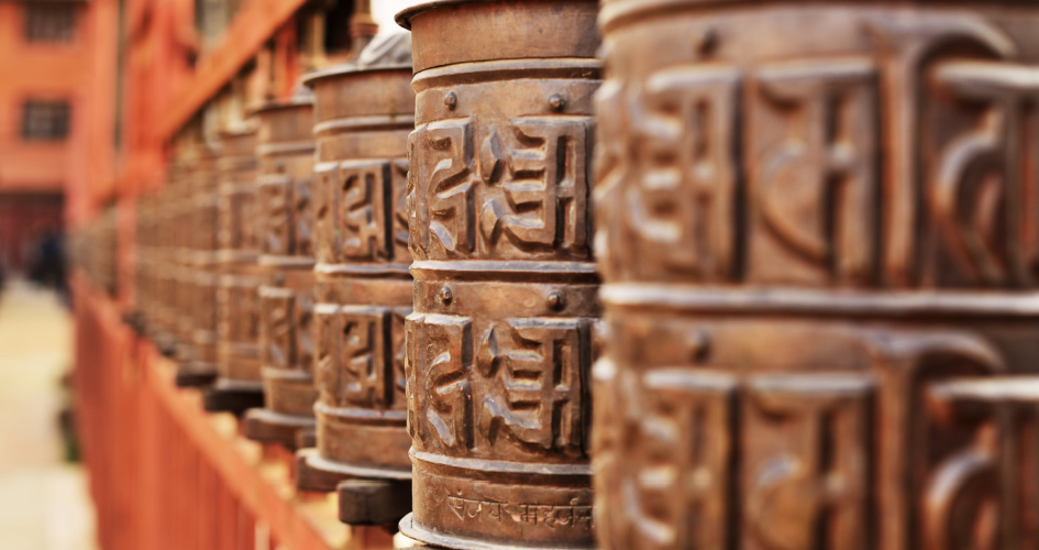 Praying drums with Sanskrit symbols. Concept of Sanskrit translation services.