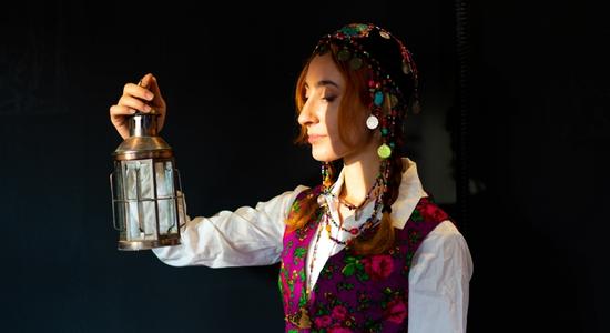 Kurdish woman standing on a black background. Concept of Kurdish translators.