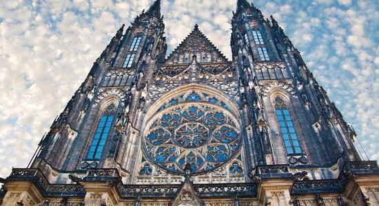 View from the ground of historic St. Vitus Cathedral in Prague. Concept of English to Czech translation.
