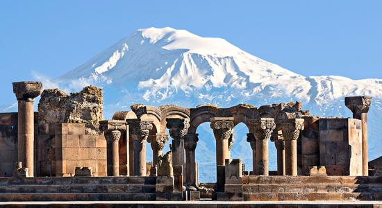 The ruins of ancient temple, Zvartnots, with Mount Ararat in the background. Concept of English to Armenian translation.