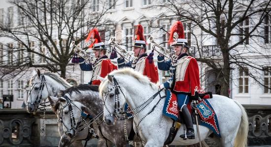 Danish soldiers in uniform on horseback.