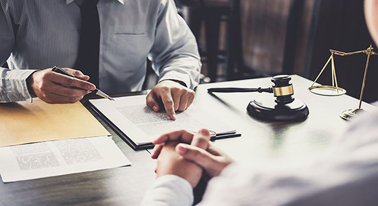 Man signing a contract on table. Concept of legal Korean translation. 
