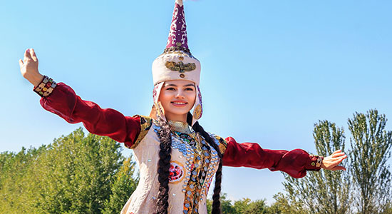 A happy Kazakh girl wearing traditional dress in Almaty. Concept of a Kazakh translator. 