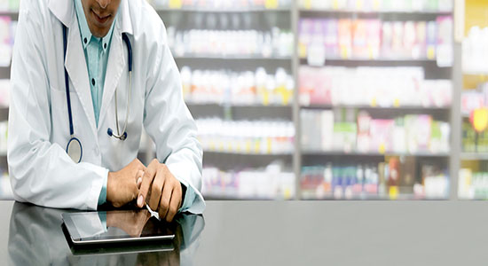 Male pharmacist working in drug store. Concept of medical Hungarian translation.