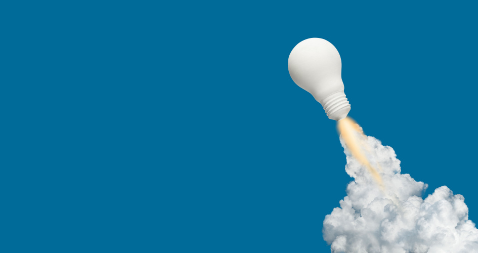 A white light bulb taking off like a rocket against blue background. Concept of multilingual SEO translation for websites and SEO translated content into multiple languages.