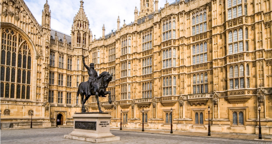 Dark gray statue of Richard I of England outside of British Parliament. Concept of government translation services by professional government translators.