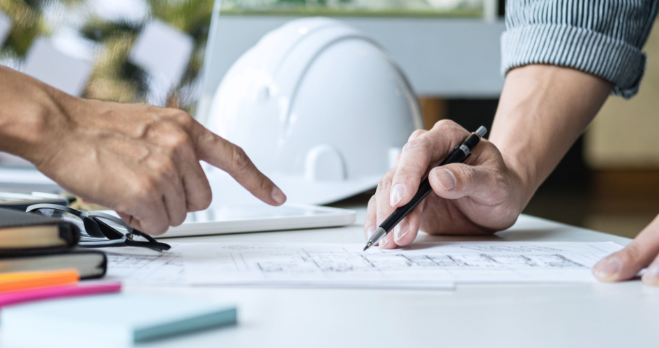 Man holding a pen and another hand pointing. Concept of technical translation and technical translators.