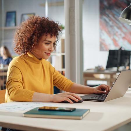 Handsome multiethnic woman working on computer in office.