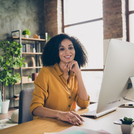 Smiling professional woman working on her computer in the office. 