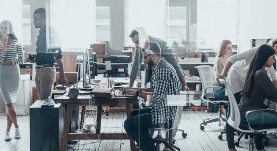 Company's staff working in an open office. Concept of business translation services.