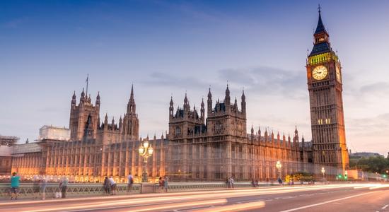 Night view of the Westminster and the Big Ben in London city. Concept of government translation services.