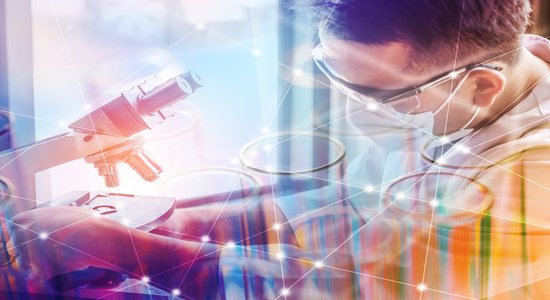 Scientist in lab gear working with microscope, colourful triangular graphics overlaid. Concept of scientific translation services.