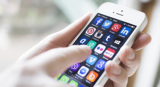 Close-up of a hand moving across an iPhone screen. 